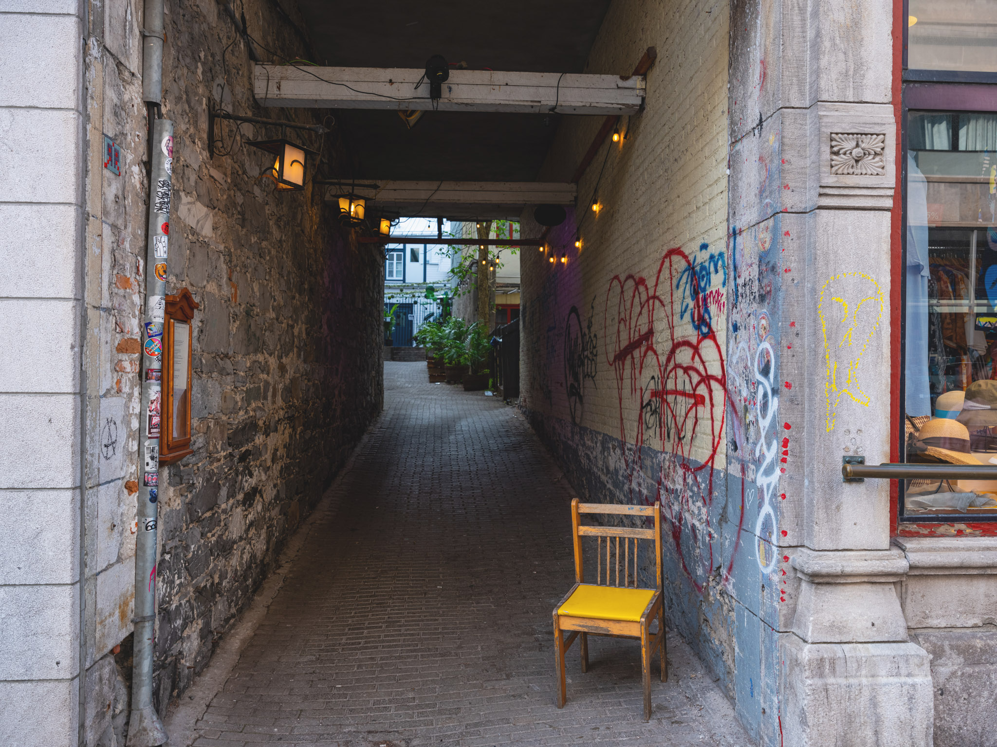 Yellow chair in an alley way